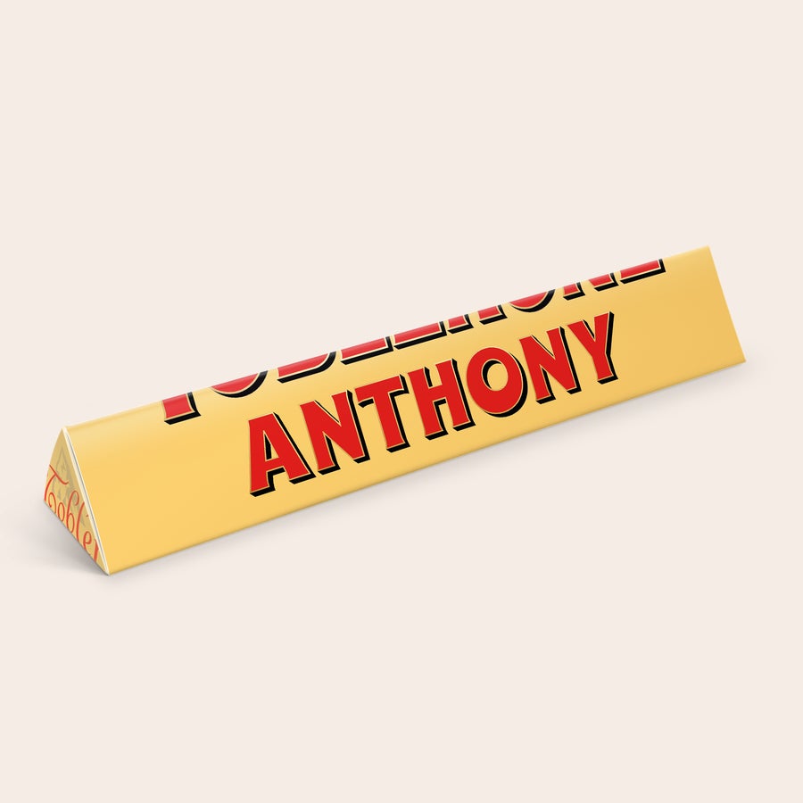 Personalised Toblerone Chocolate Bar Personalised Toblerone bar with red text ANTHONY printed on the golden packaging