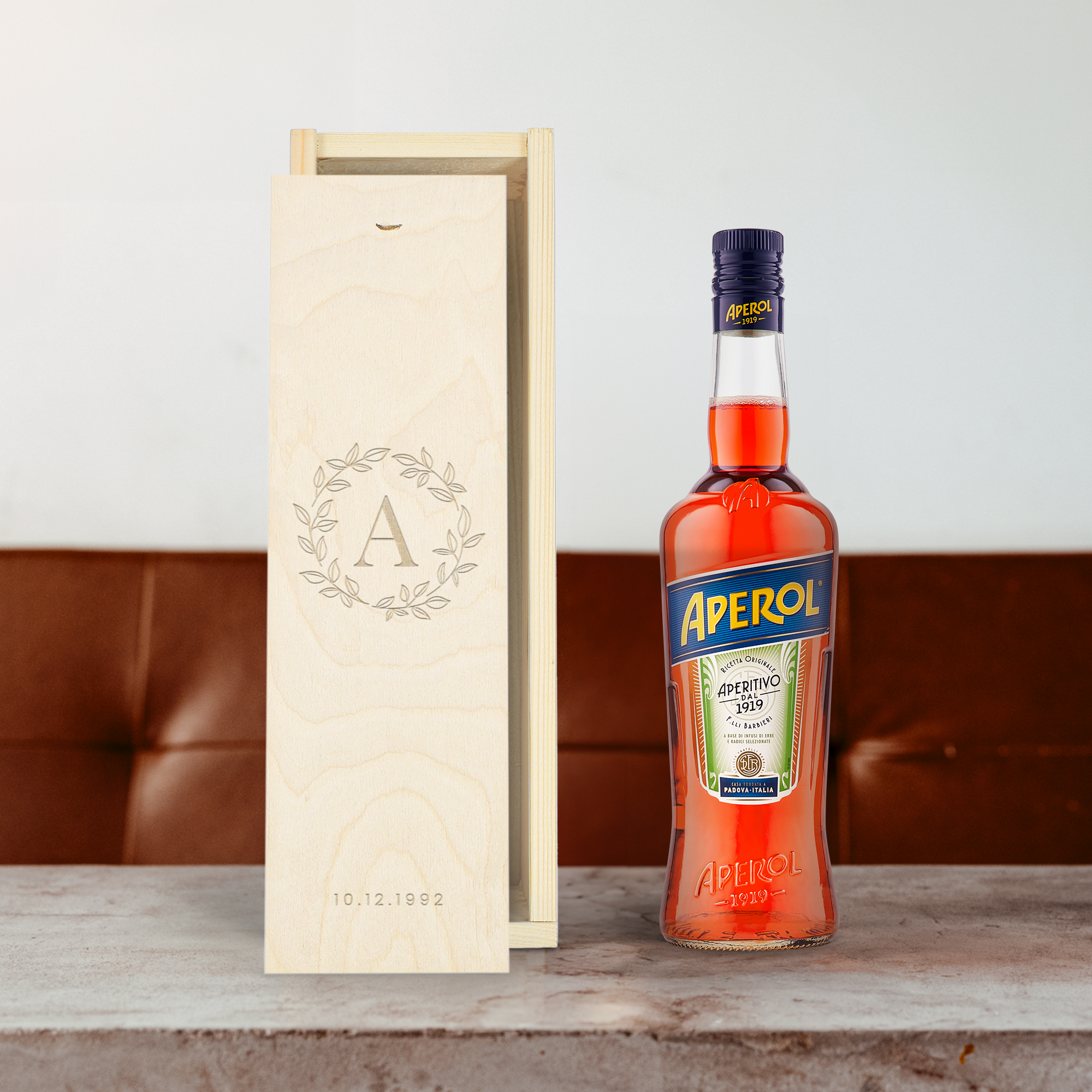 Aperol liqueur bottle in an engraved wooden case with a personalized initial and date