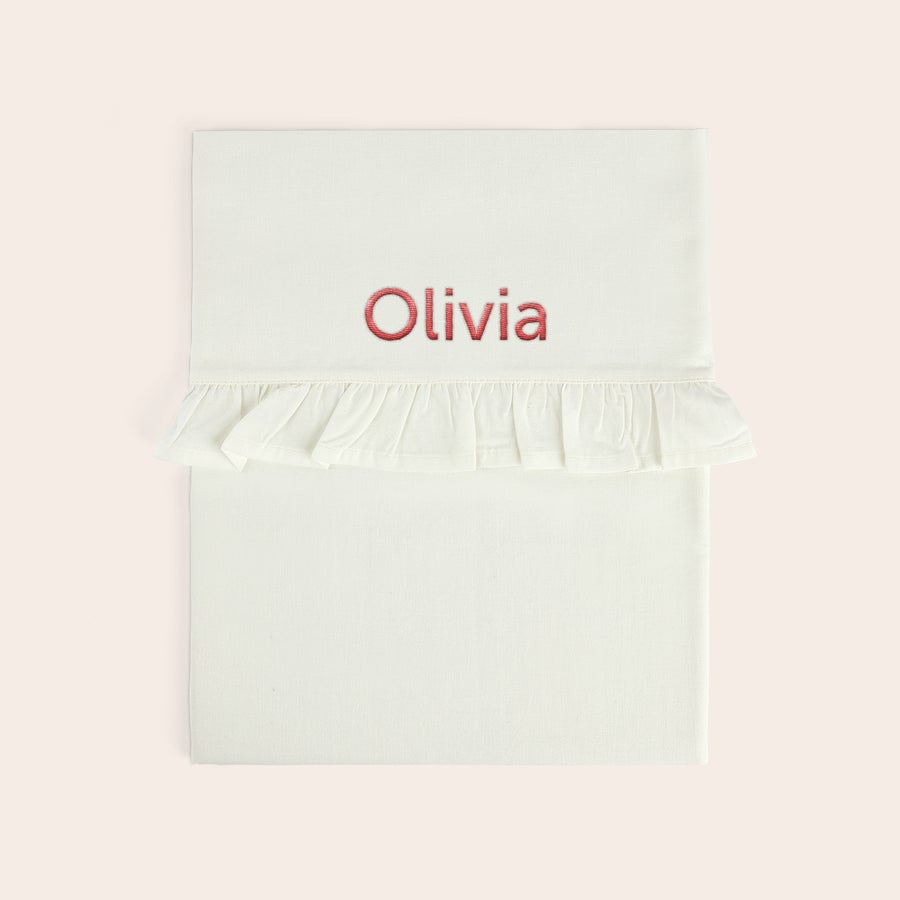 Sábana para cuna bordada - Borde con volantes Sábana blanca de moisés bordada con el nombre Olivia en rosa, con un volante. ¡Sorprende a tus seres queridos con una sábana de moisés bordada personalizada!