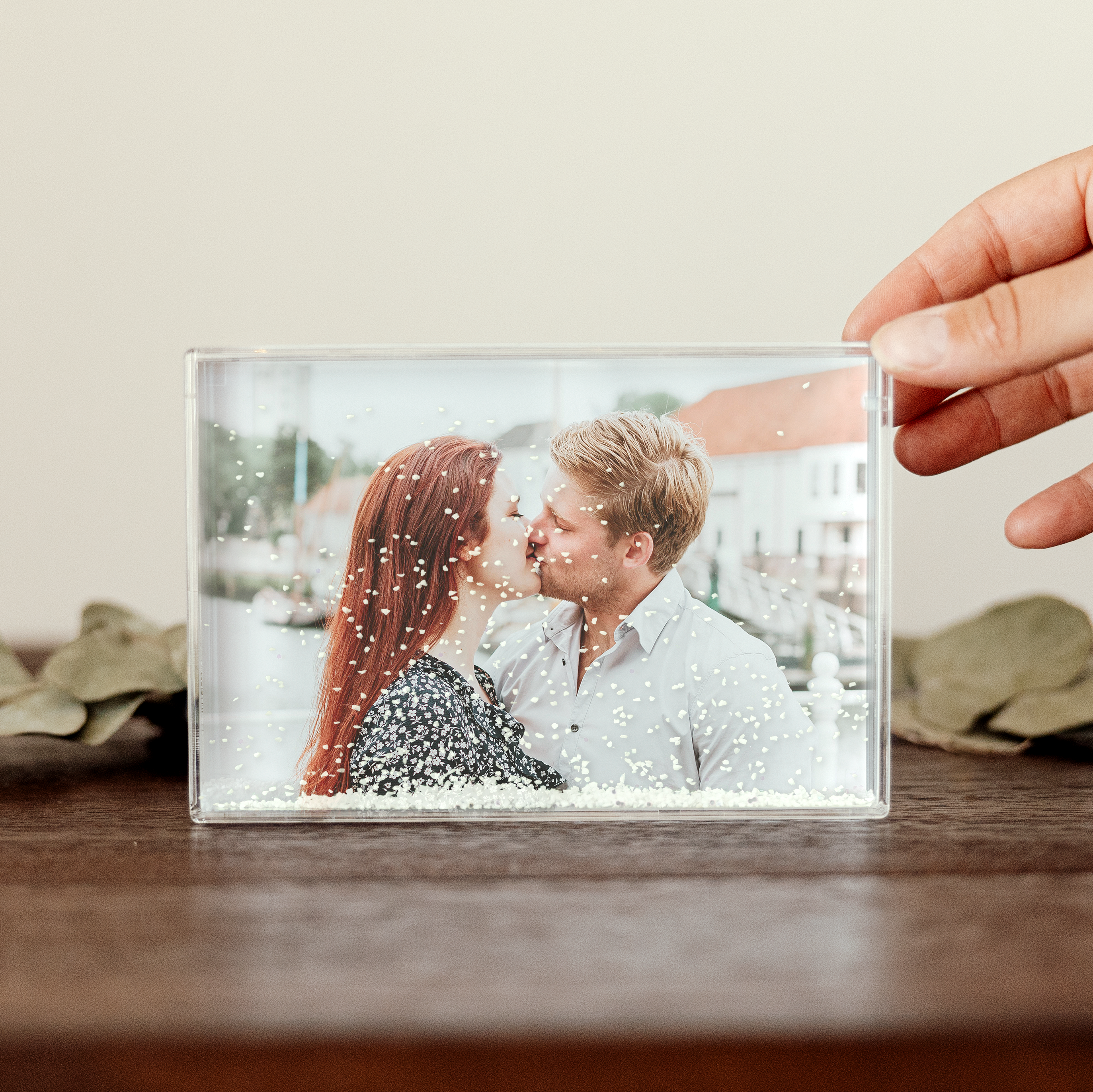 Blocco fotografico personalizzato in plexiglas, con foto stampata di due persone che si baciano e fiocchi di neve interni