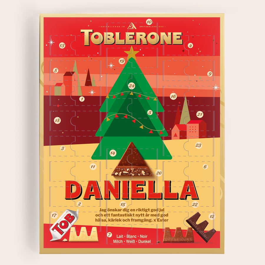 Personliga Adventskalender - Toblerone 2025 Personlig adventskalender med Toblerone, designad med namnet "Daniella" och texten "Jag önskar dig en riktigt god jul".