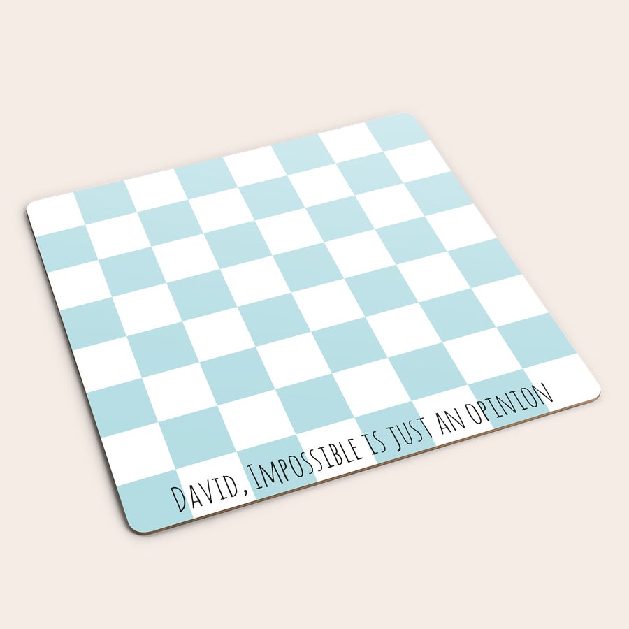 Juego de ajedrez personalizado  Un juego de ajedrez personalizado con cuadrados azules y blancos, y un mensaje impreso con el texto David, impossible is just an opinion.