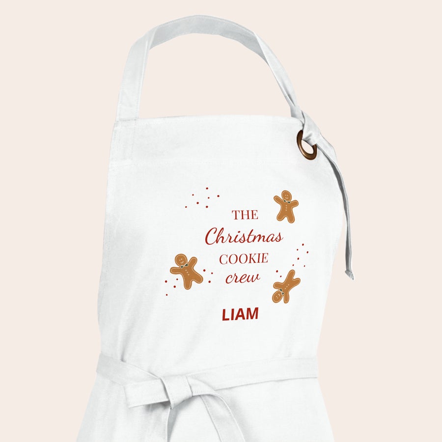 Forkle Hvit personlig kjøkkenforkle trykt med pepperkaker, teksten "The Christmas cookie crew" og navnet LIAM.