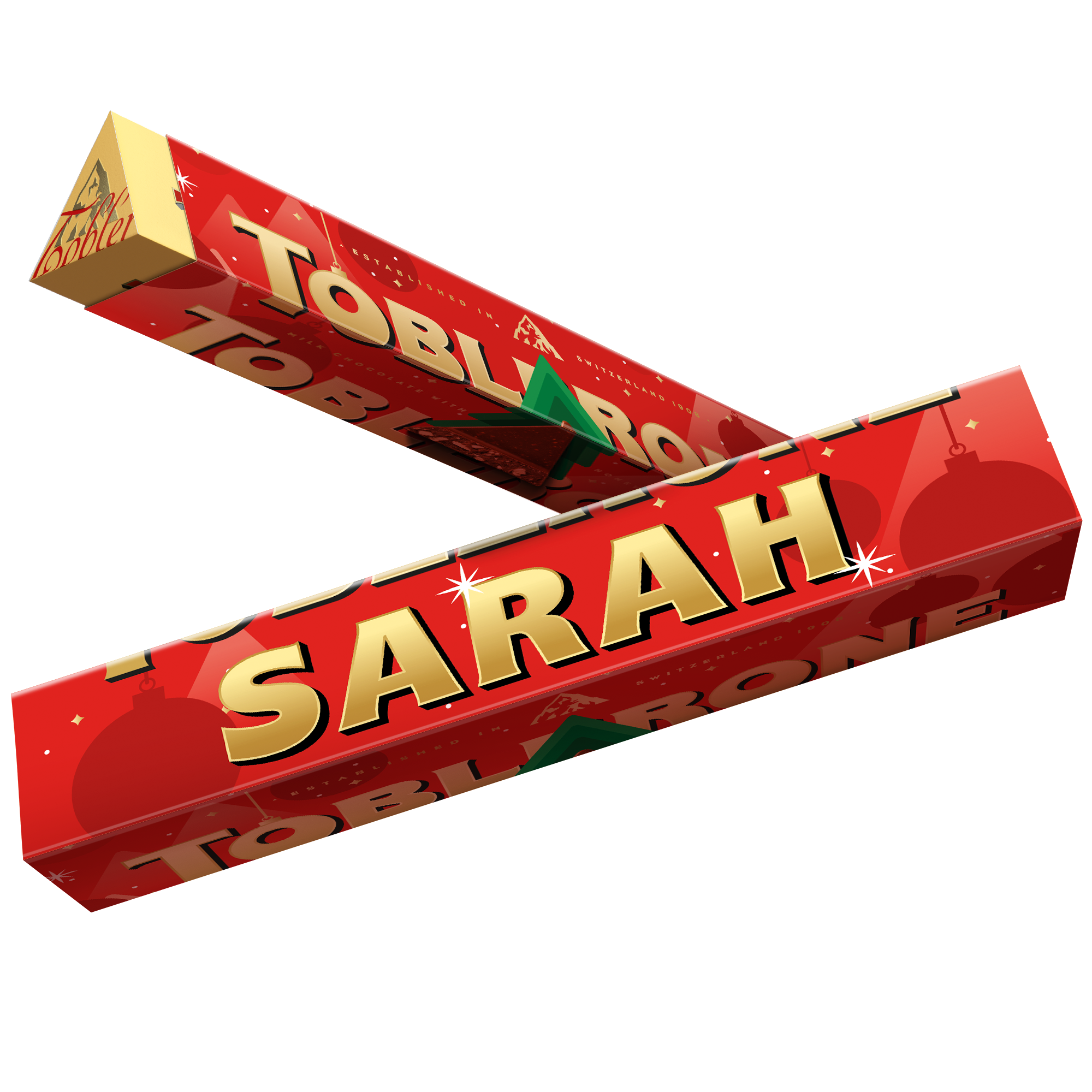 Röd personaliserad Toblerone med julmotiv, tryckt med namnet Sarah. Lägg en personaliserad Toblerone i under granen.