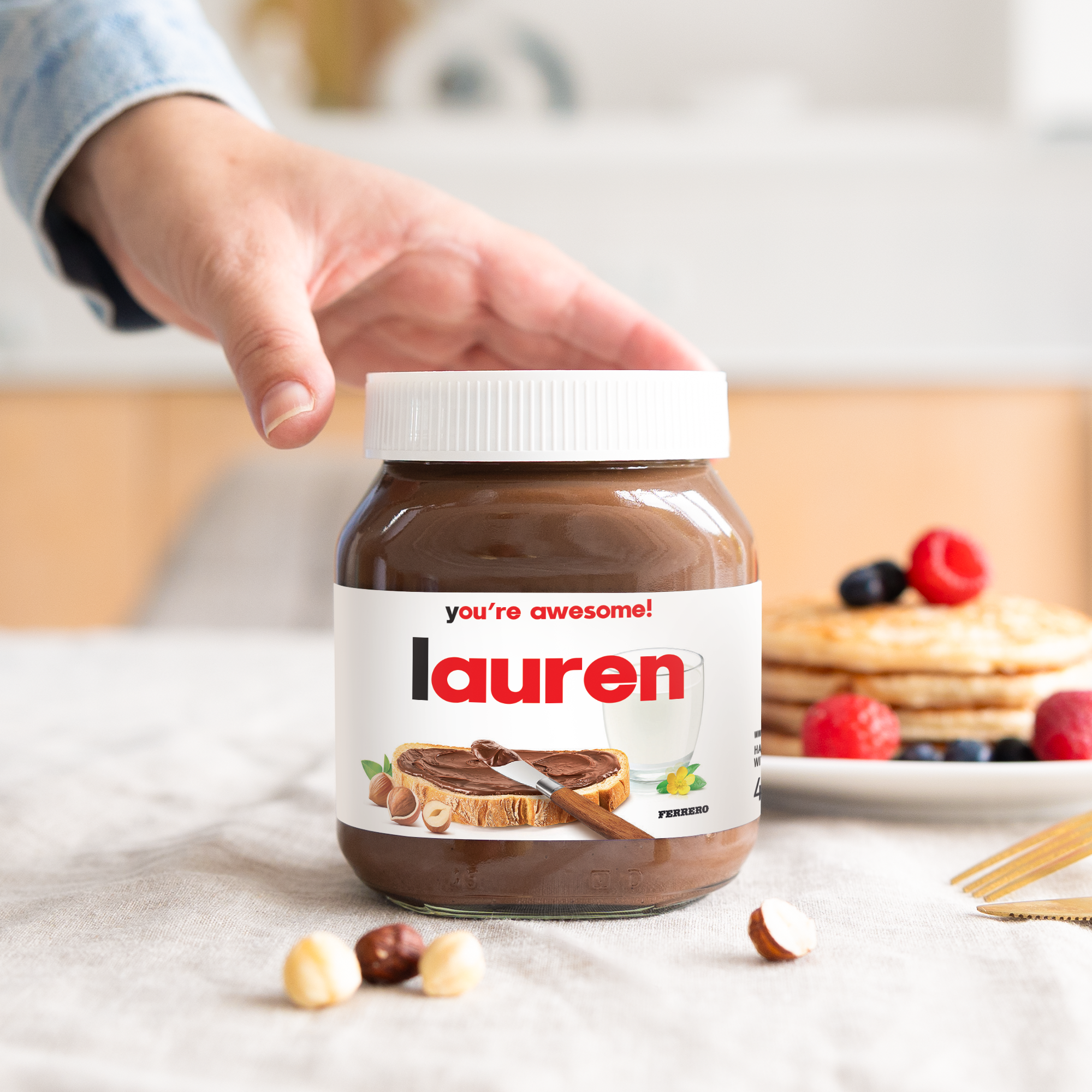 Personalised nutella® jar - 450 gr - Original with "you're awesome!" and "Lauren" printed on the label, held by a hand.