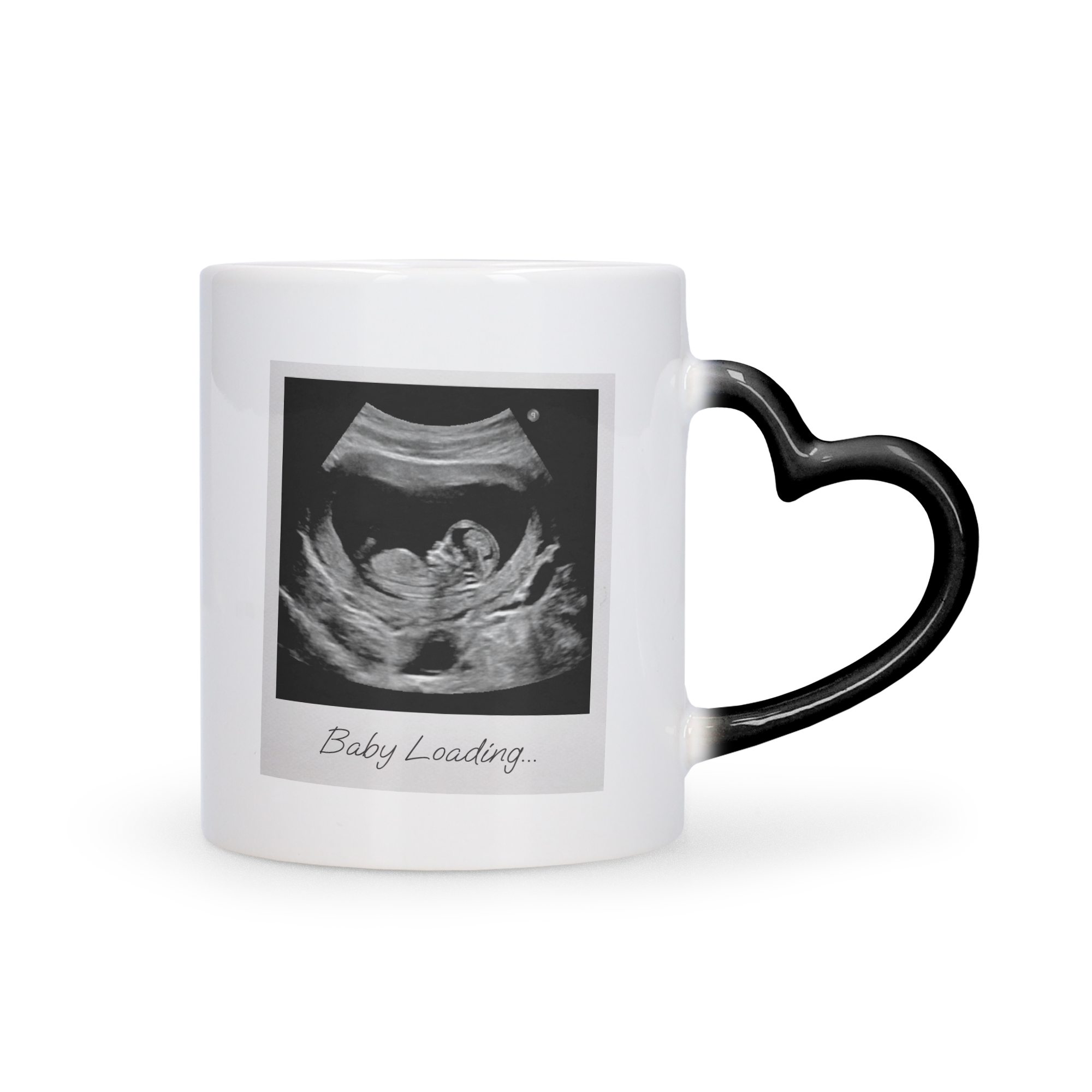 Personalized magic photo mug with a black heart-shaped handle and a printed ultrasound image and "Baby Loading..." text