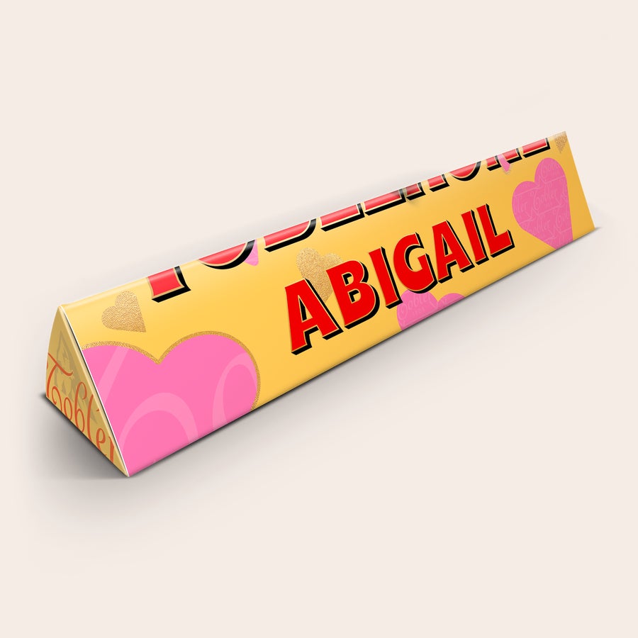Romantyczna Czekolada Toblerone Romantyczne pudełko czekolady Toblerone z imieniem ABIGAIL, nadrukiem różowych serc i złotych detali