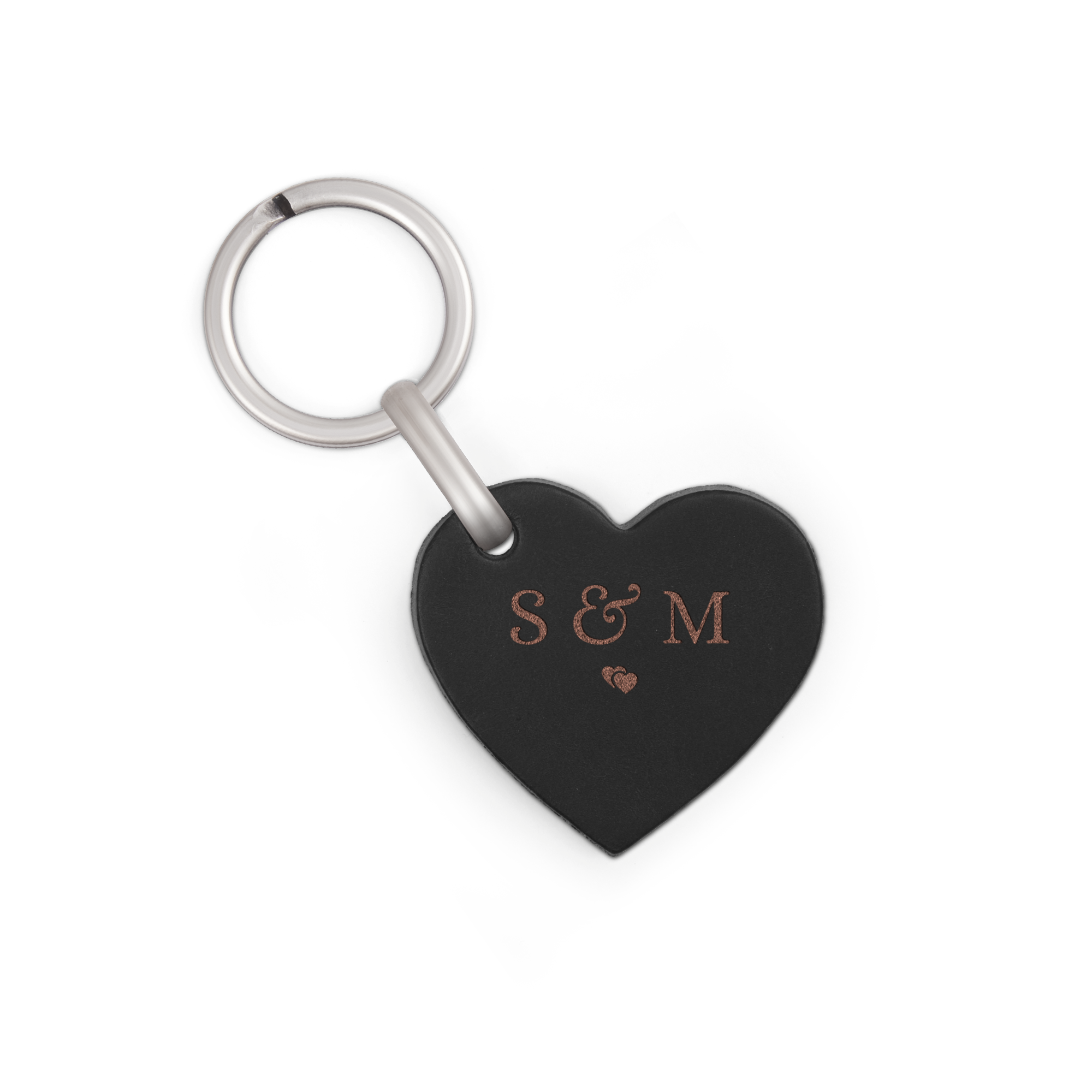 A personalised heart-shaped leather keyring with "S & M" and a small heart engraved