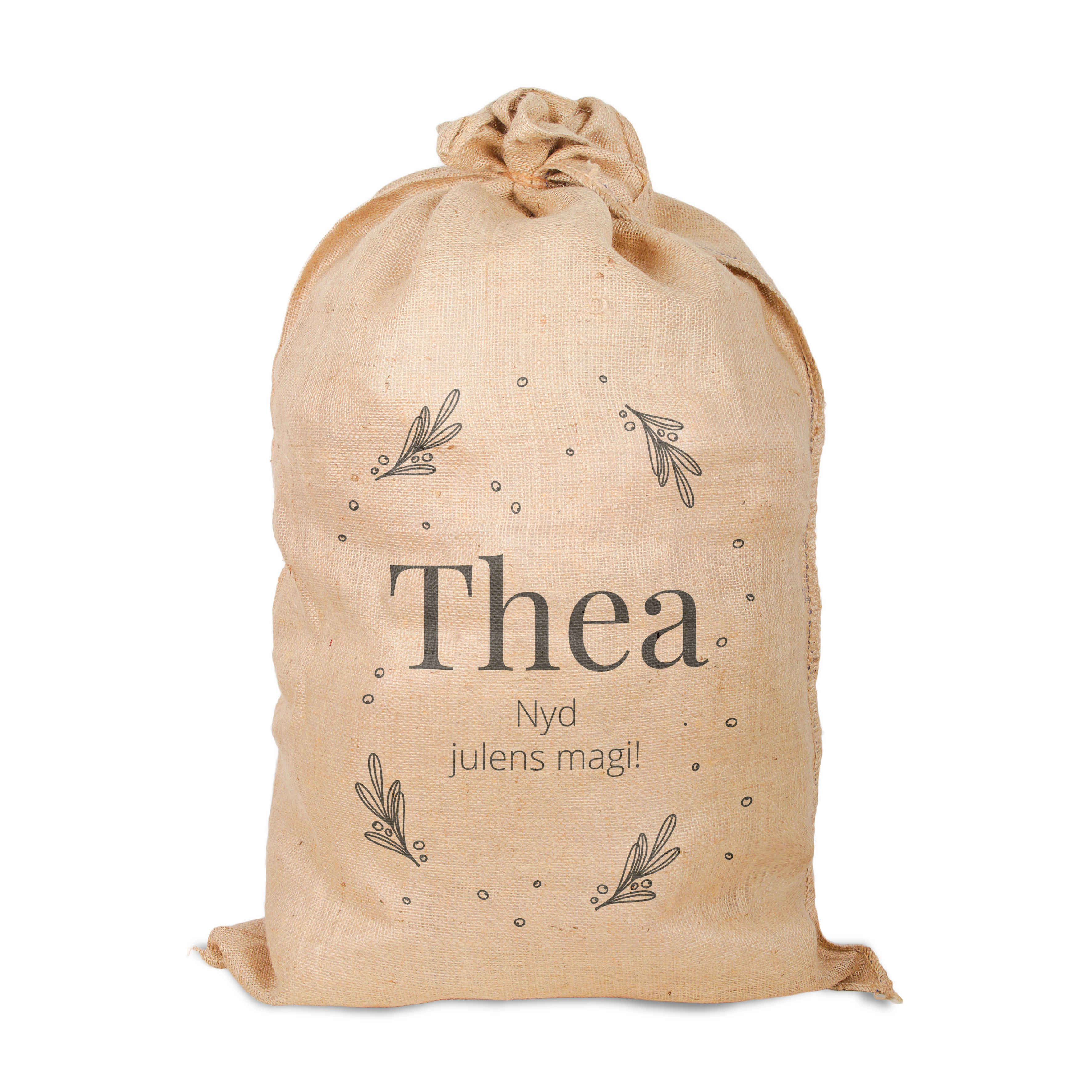 Personlig jutesæk med "Thea Nyd julens magi!" trykt på og design med mistelten.