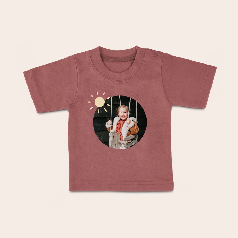 Personalised baby t shirt Pink baby shirt with a custom printed photo of a child on a swing and a sun graphic, a stylish baby shirt.