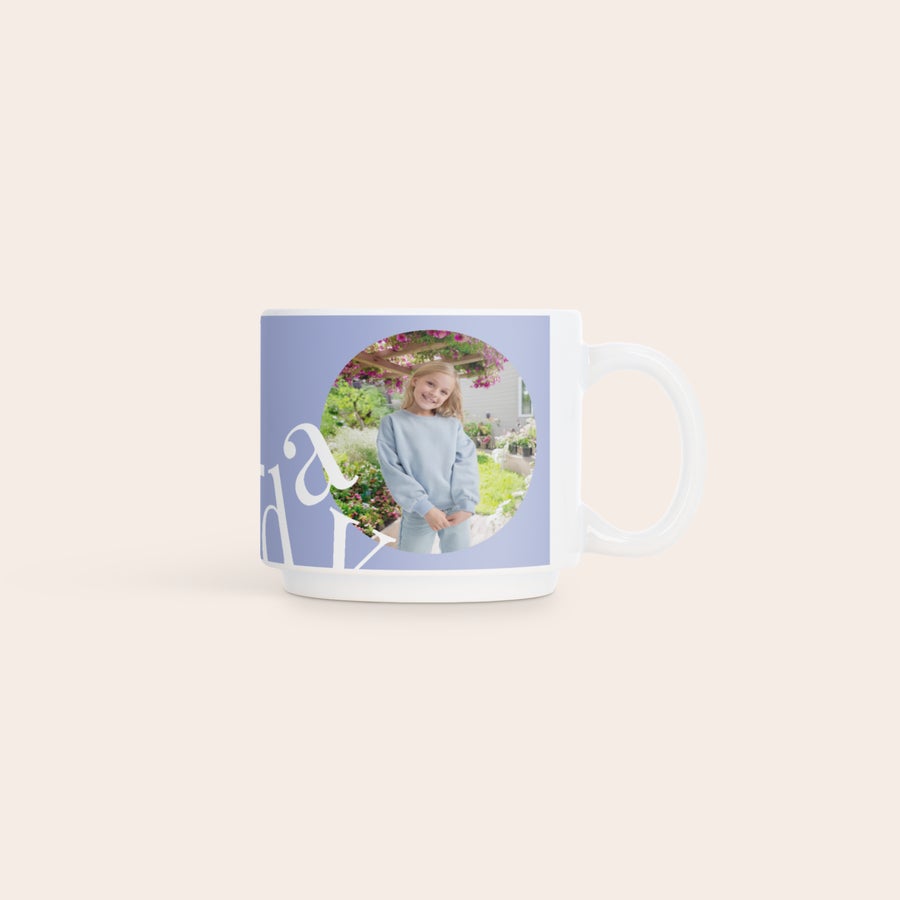 Stackable mugs with photo White stackable photo mug with a printed picture of a smiling girl in a garden. The custom stackable photo mug has a blue background and white text.
