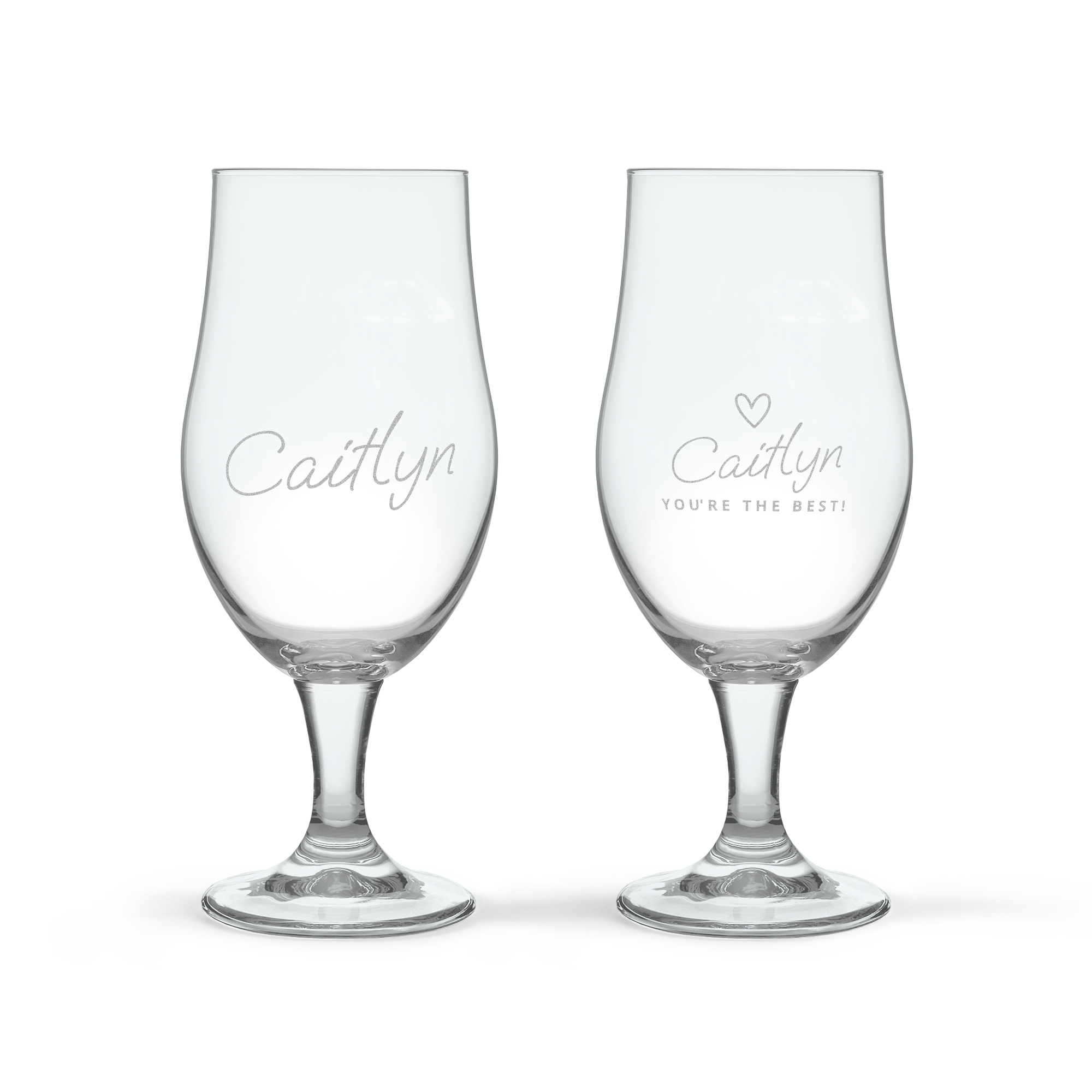 Two dark beer glasses, each engraved with the name Caitlyn. One glass also says YOU'RE THE BEST! with a small heart.