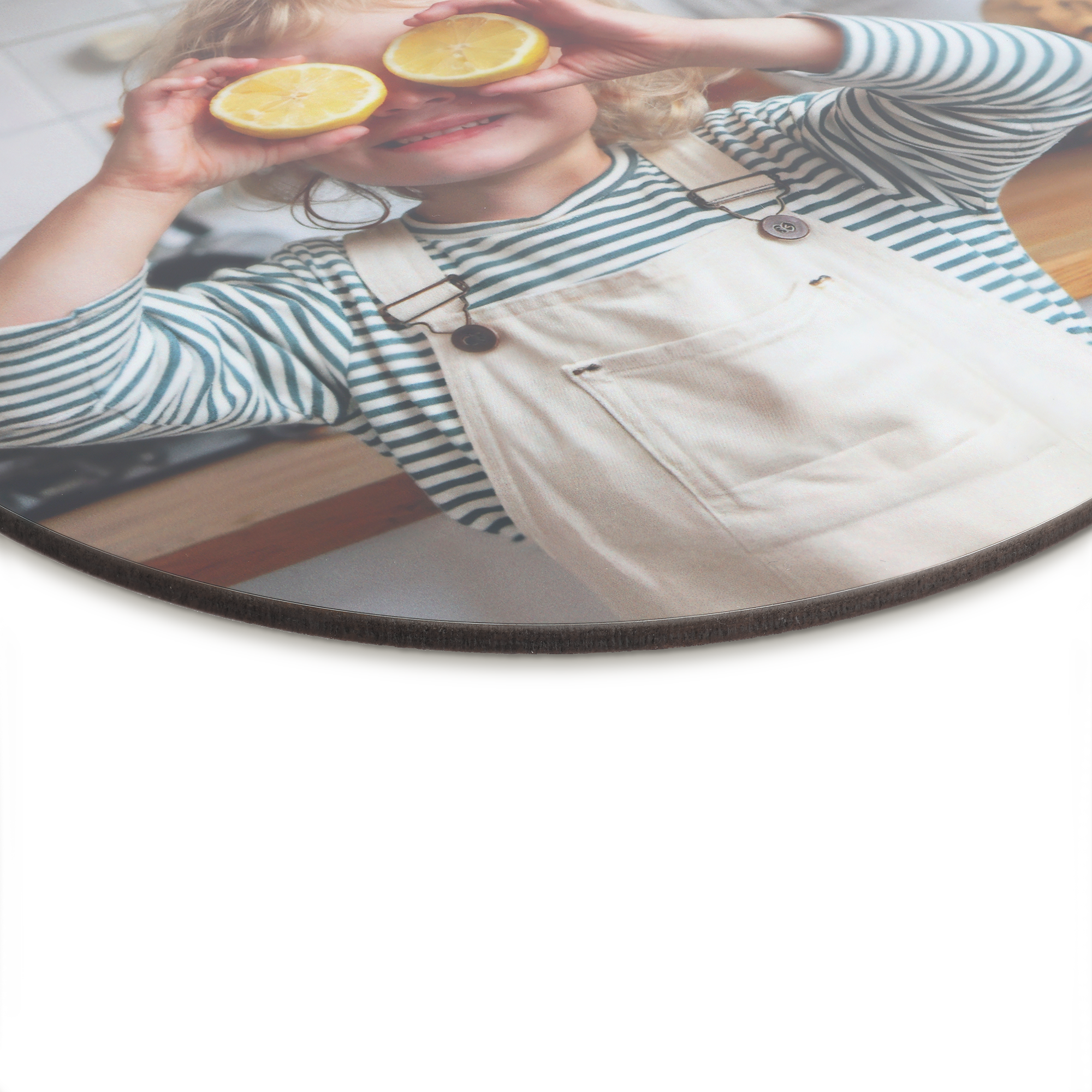 Round personalized wooden wall art panel with a printed photo of a child holding lemons over their eyes