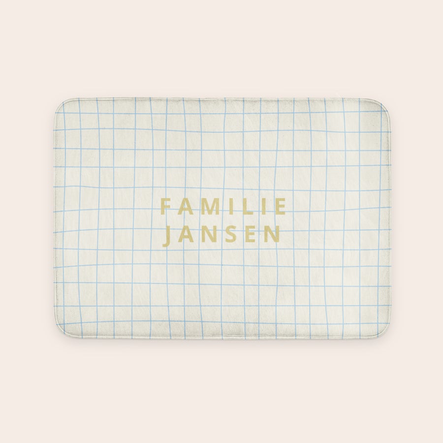 Badmat bedrukken - 70 x 50 cm Witte gepersonaliseerde badmat met blauwe rasterlijnen en de opdruk "FAMILIE JANSEN" voor een persoonlijke oase.