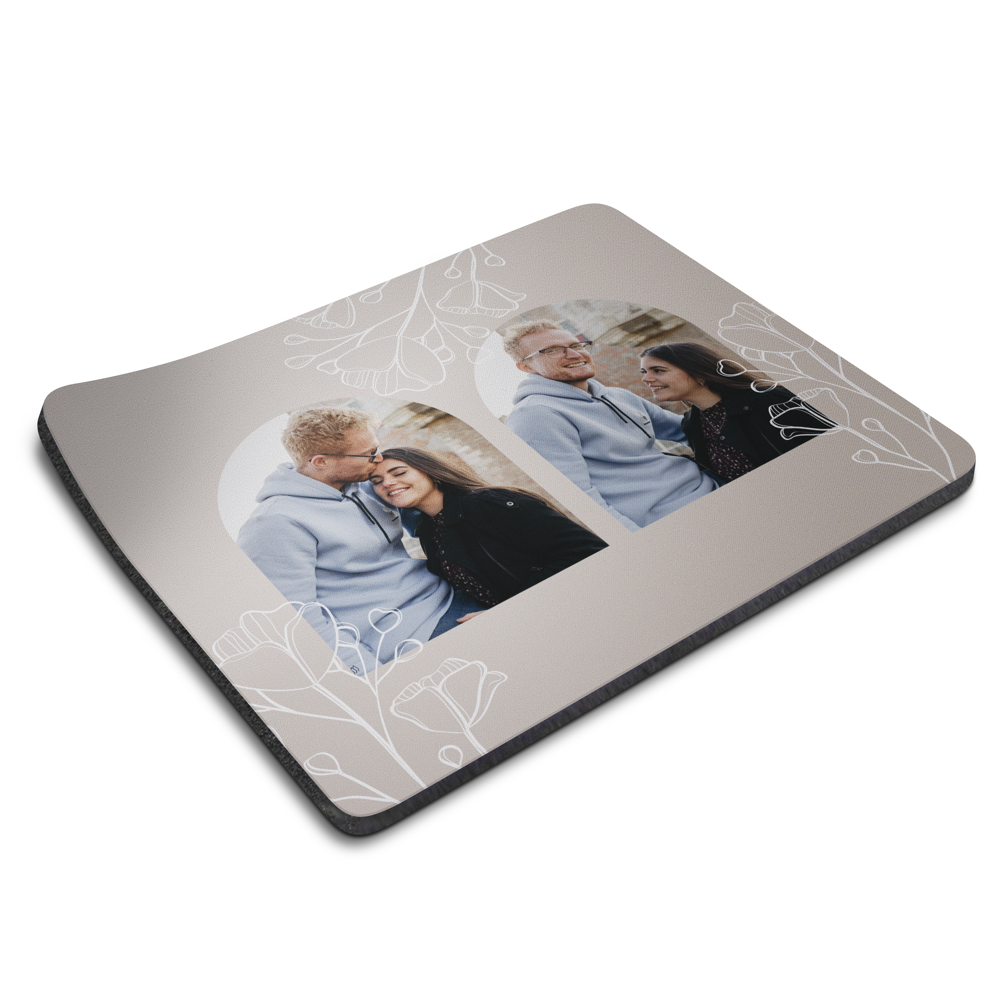 A personalized mouse mat with two printed photos of a couple and a subtle white floral design.