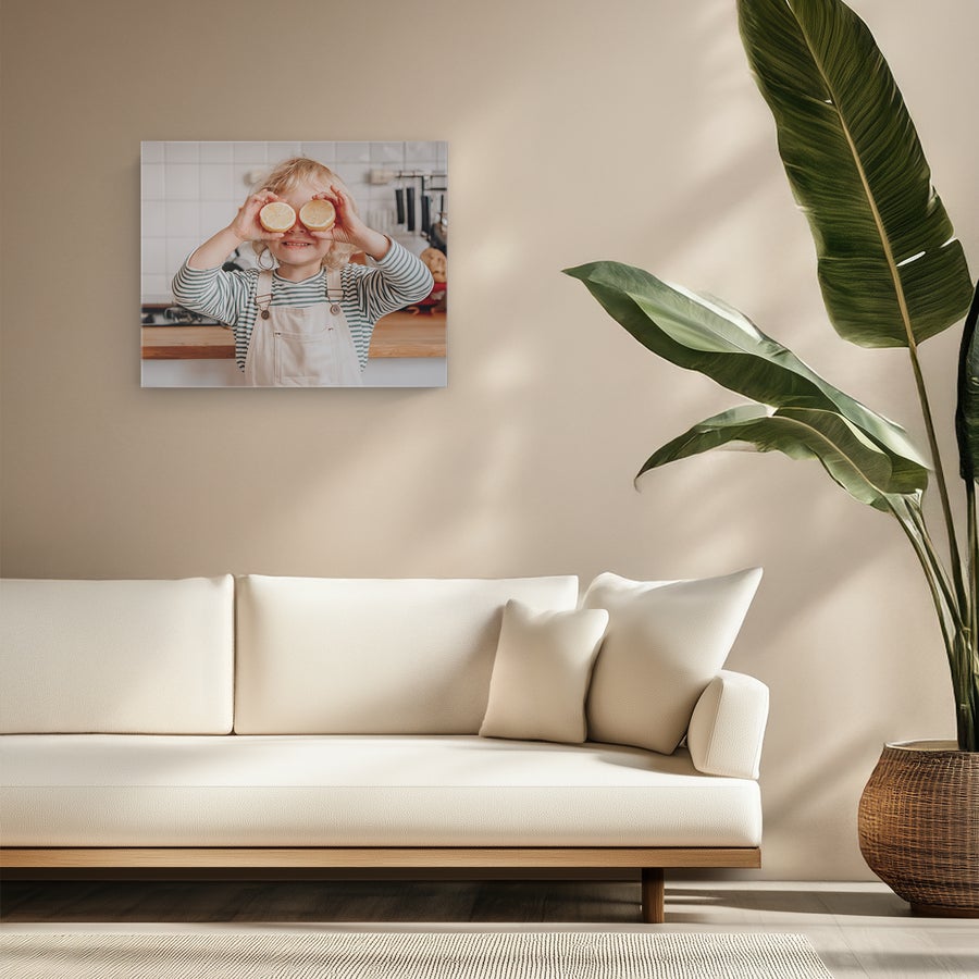 Personalised photo canvas A personalized photo canvas of a child holding lemon halves over their eyes, printed from a cherished photo