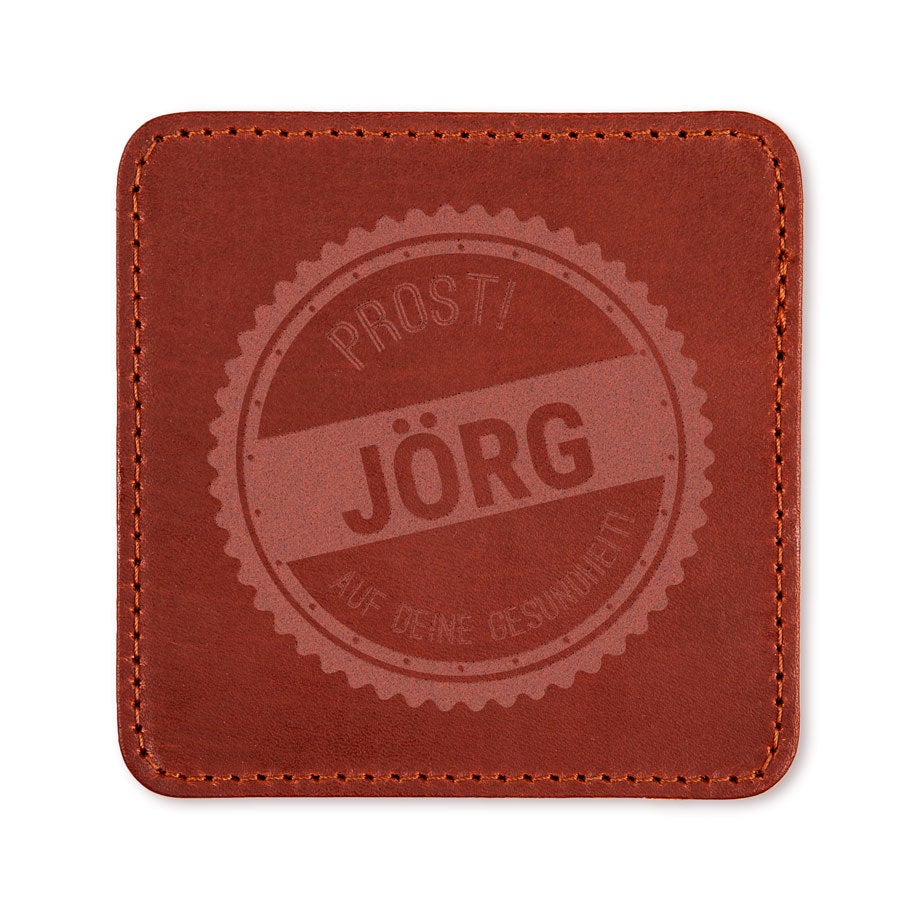 Brauner Lederuntersetzer mit "Prost Jörg auf deine Gesundheit" in einem runden Design lasergraviert