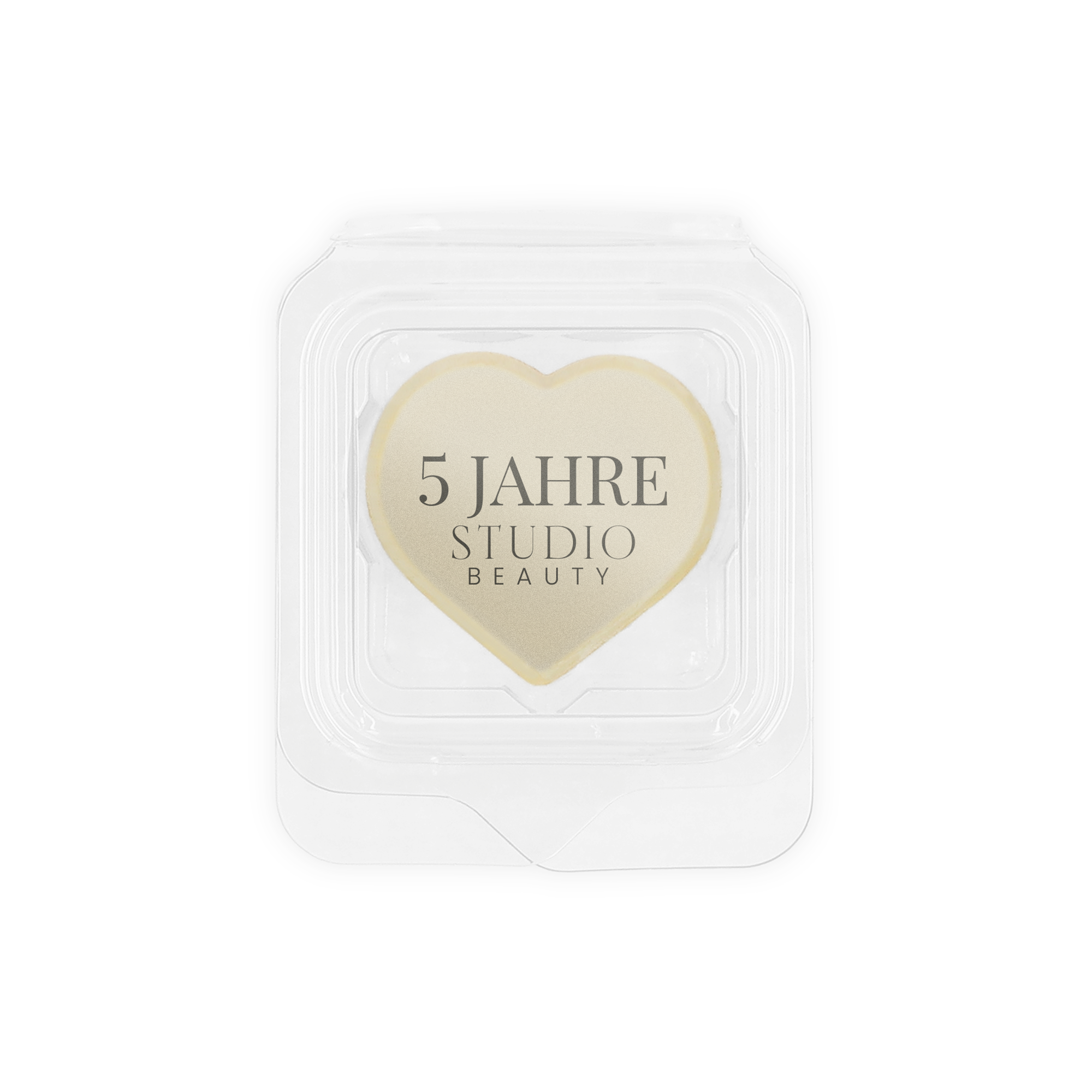 Weiße, herzförmige Fotopraline bedruckt mit dem Text "5 Jahre Studio Beauty" als individuelles Gastgeschenk.