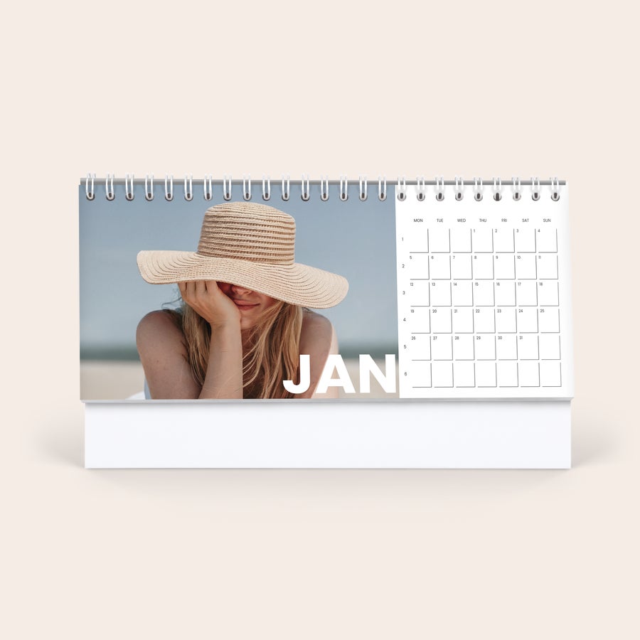 Calendar desktop personalizat Calendar de birou personalizat, imprimat cu o fotografie cu o fată zâmbitoare și cuvântul JAN.