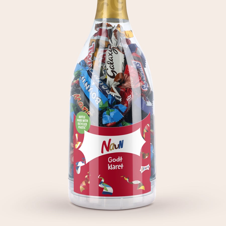 Personlig  Celebrations gave Gennemsigtig champagneflaske fyldt med Celebrations chokolader og personaliseret etikette med navn og teksten Godt klaret