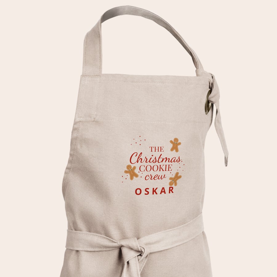 Kinderschürze personalisiert Beige Kinderschürze mit Weihnachtsmotiv und dem Namen Oskar bedruckt