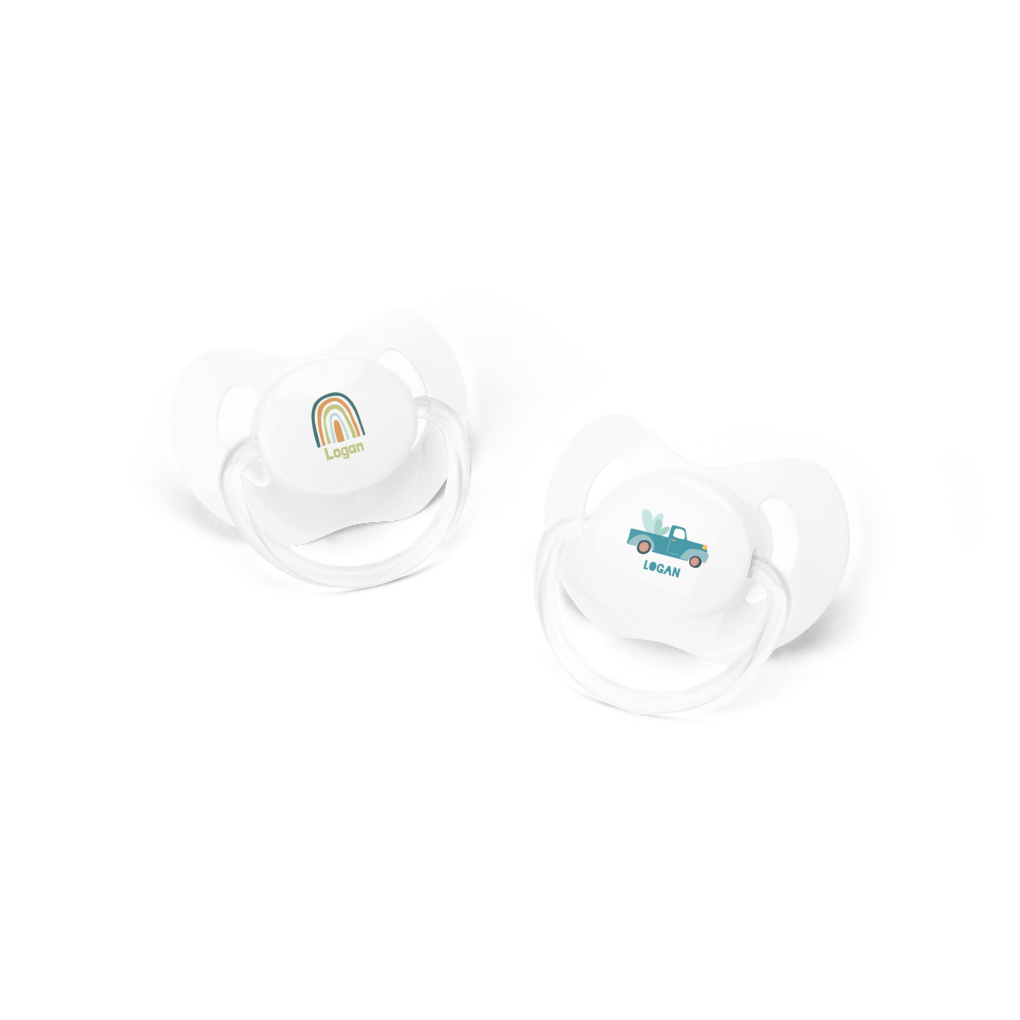 White personalized dummies with the name Logan printed, one with a rainbow design, the other with a blue truck.