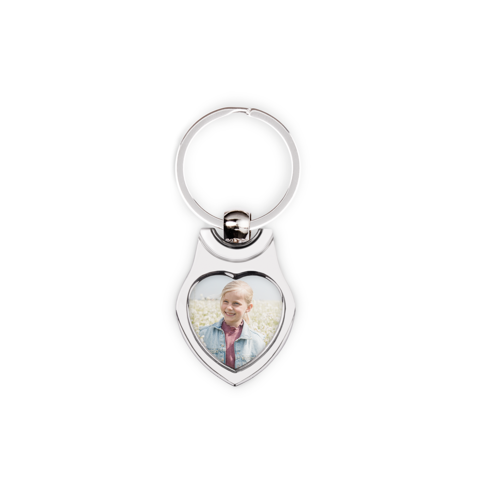 Silver heart-shaped original keyring printed with a photo of a smiling girl with blonde hair