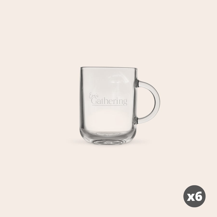 Engraved Glass Mugs A personalized glass mug engraved with the text Eves Gathering on a clear glass surface. This engraved glass mug is customizable.
