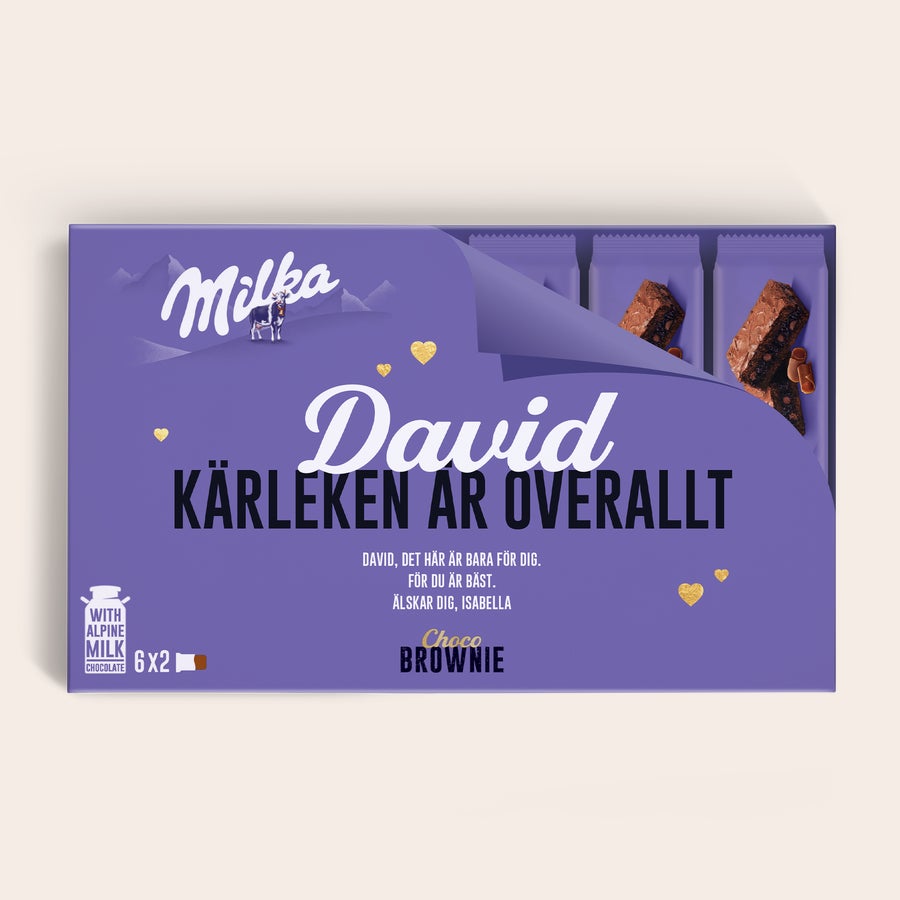 Milka Brownies Personlig Milka Choco Brownie presentask med namnet David och meddelandet Kärleken är överallt, tryckt på lila förpackning.