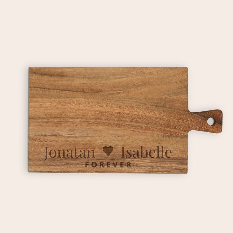 Graverad skärbräda Personaliserad serveringsplanka av teak, lasergraverad med namnen Jonatan och Isabelle med hjärta emellan, samt texten FOREVER.