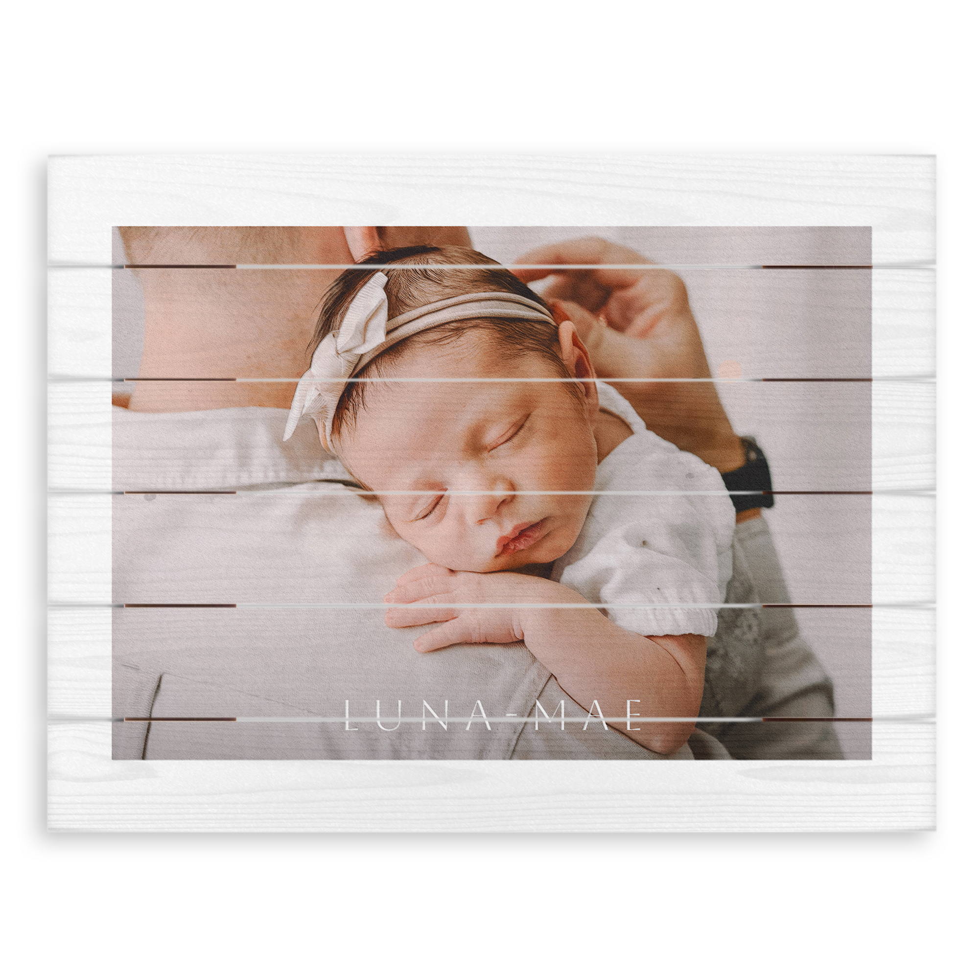 Personalized wooden photo print of a baby with a headband sleeping in an adults arms, printed with the name Luna Mae
