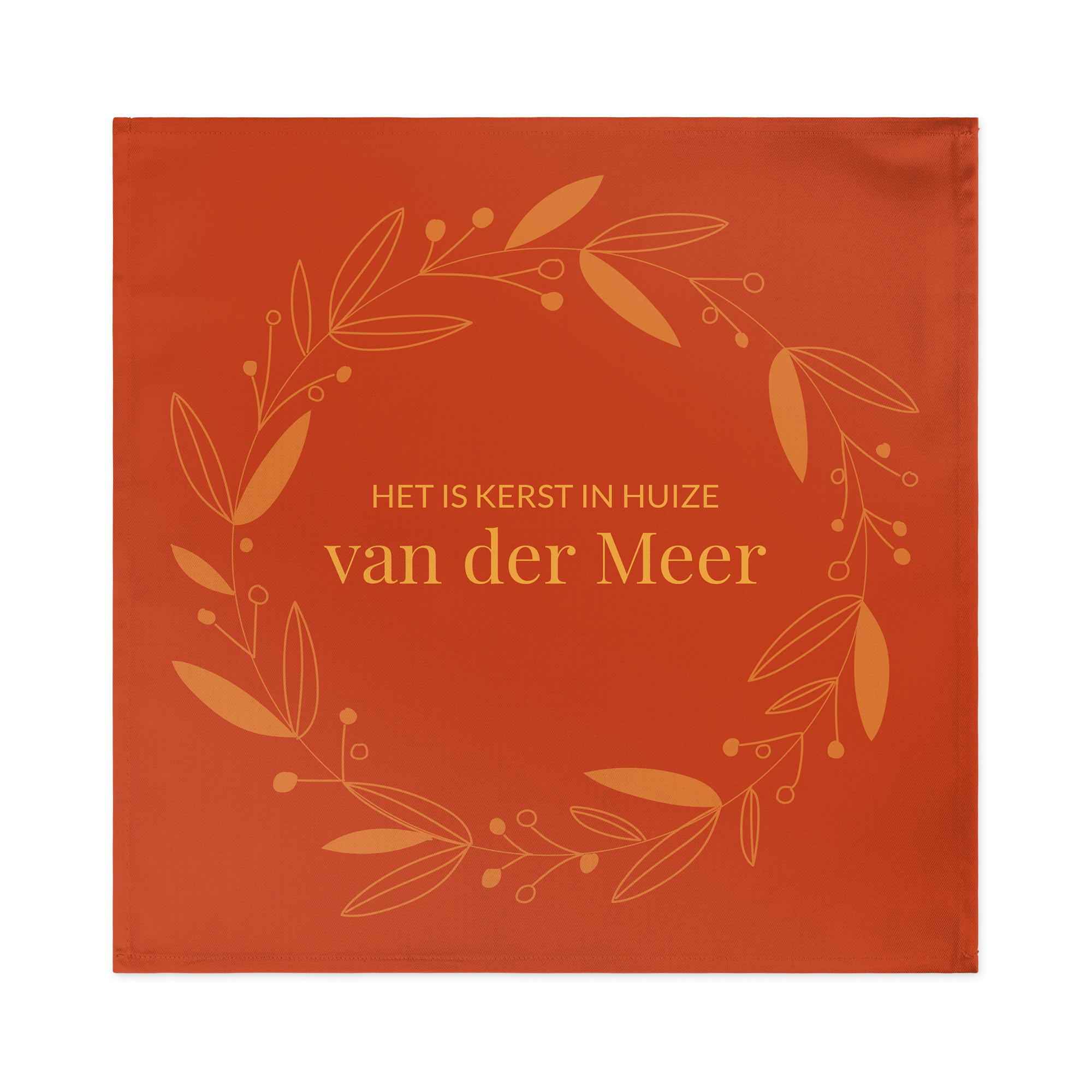 Oranje servet met kerstkrans design, bedrukt met de tekst Het is Kerst in huize van der Meer. Het dekken van de tafel wordt een feestje met unieke bedrukte servetten.