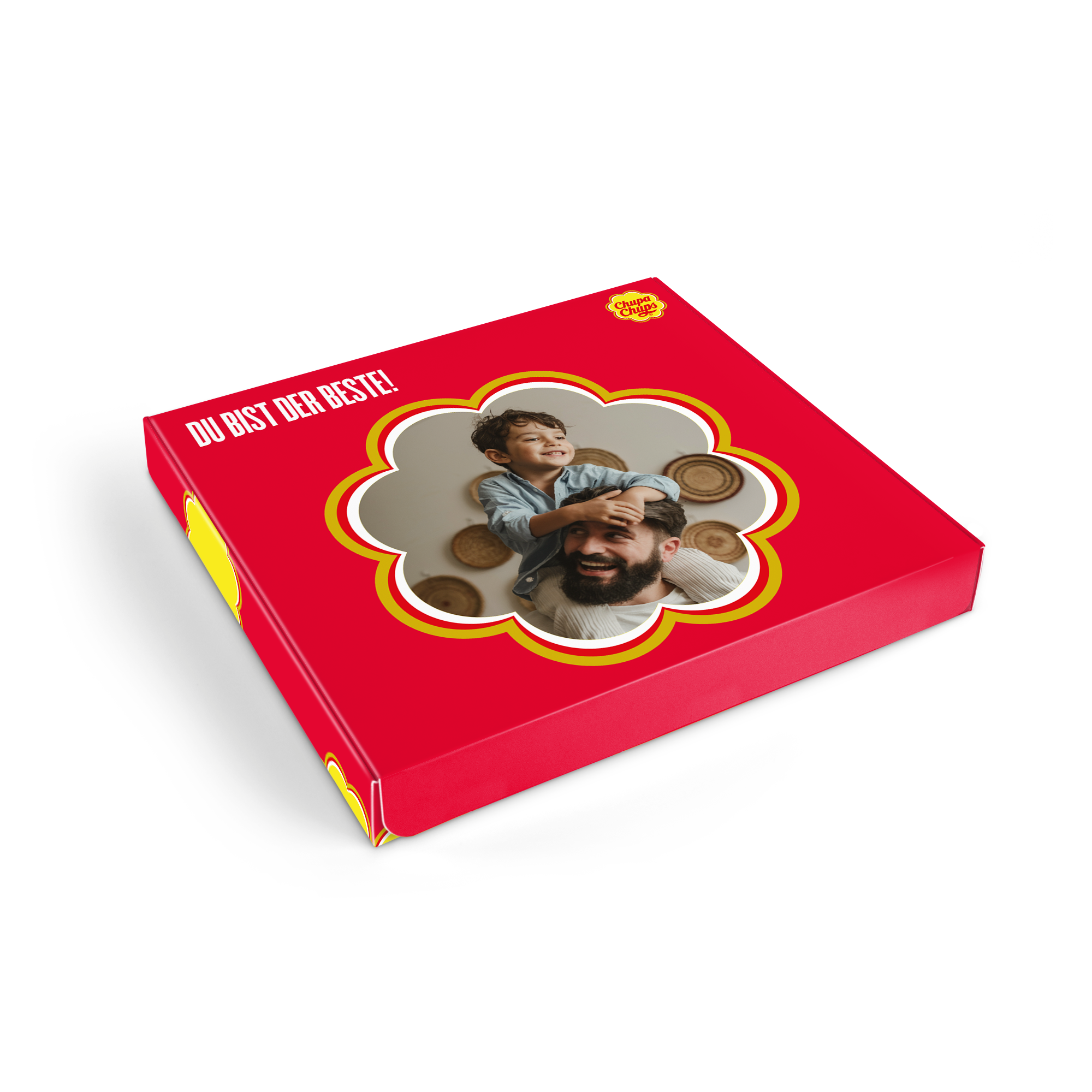 Rotes Chupa Chups Briefkastenpaket mit Foto von Vater und Sohn und Text "DU BIST DER BESTE!" gedruckt.