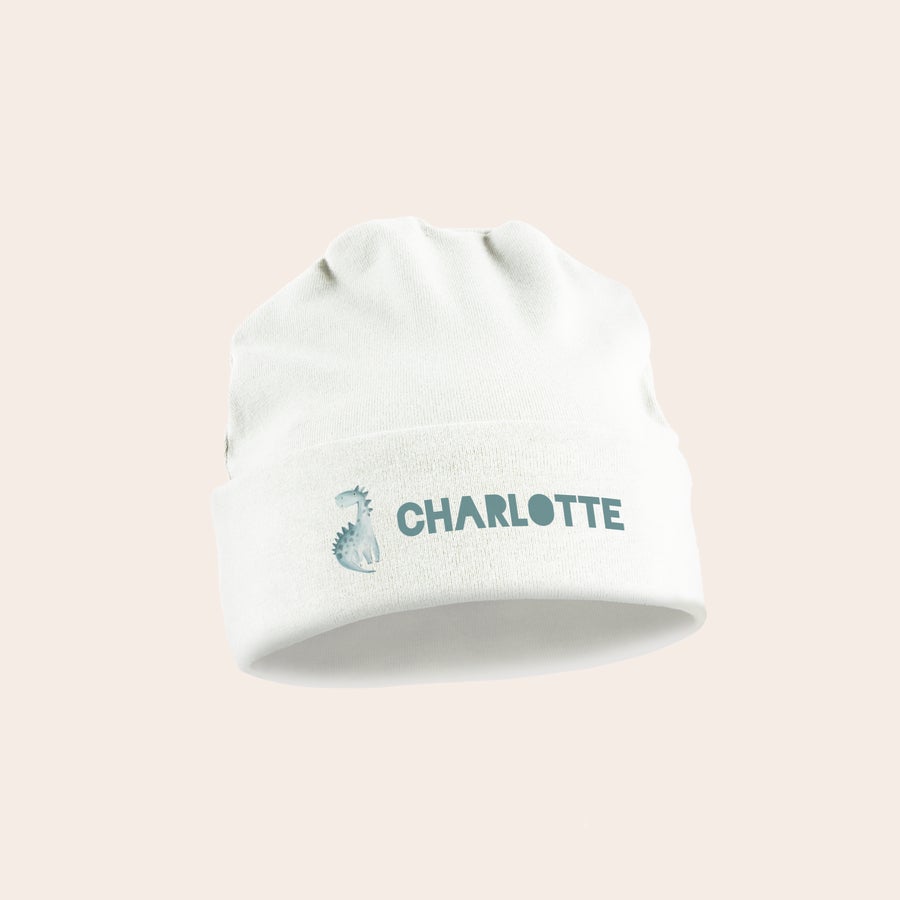 Baby lue Hvit baby lue med trykt dinosaurusmotiv og navnet "Charlotte" for en personlig gave.