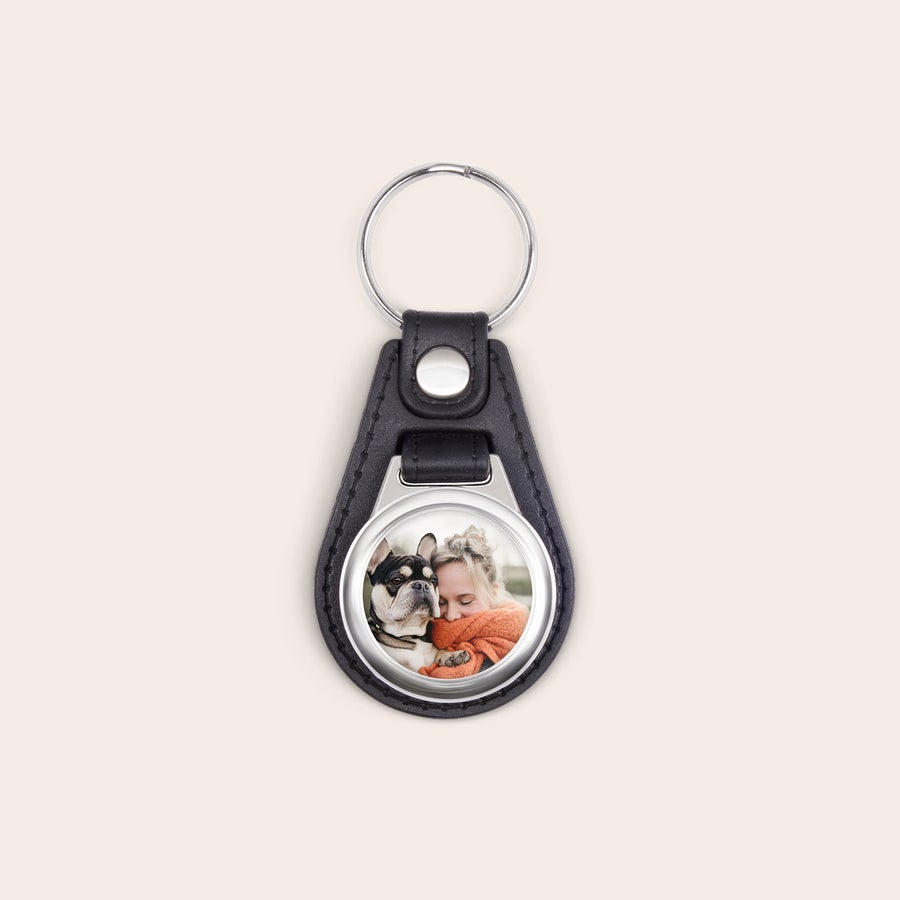 Leather keychain with photo Personalized black leather keyring printed with a custom photo of a person and a dog.