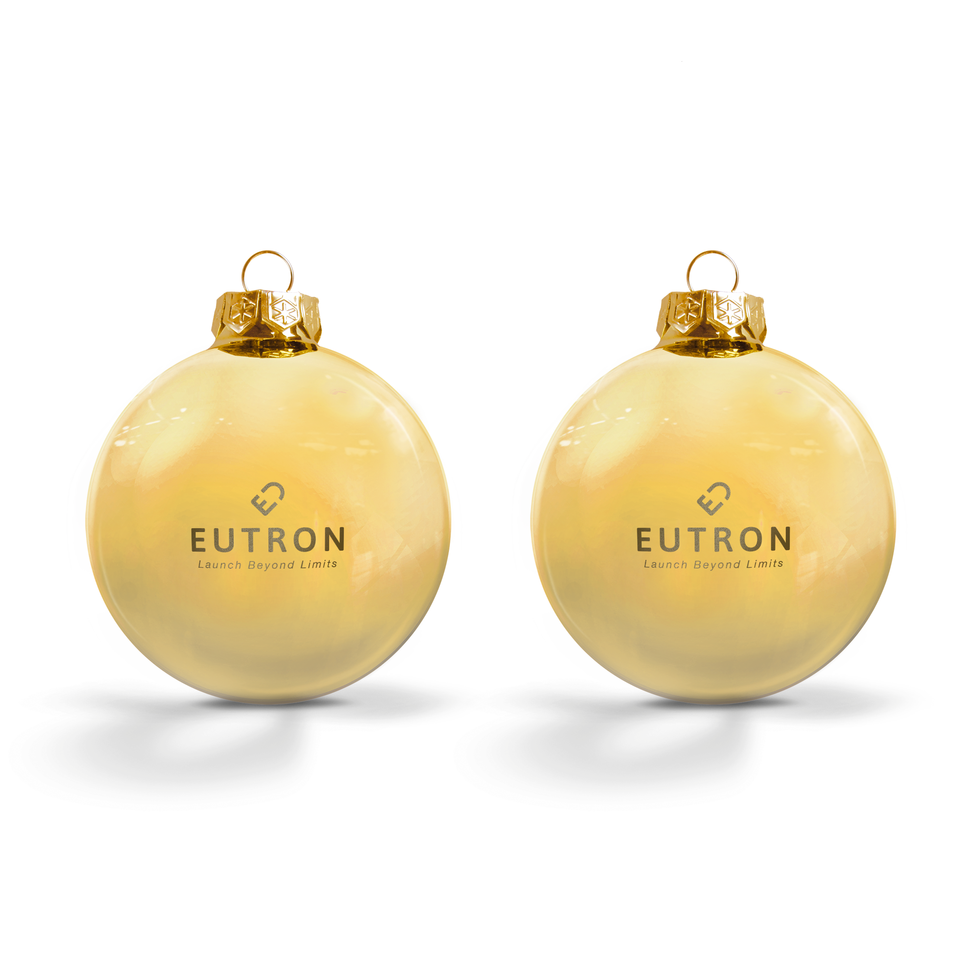 Zwei goldene Weihnachtskugeln aus Glas, graviert mit dem Text EUTRON Launch Beyond Limits.