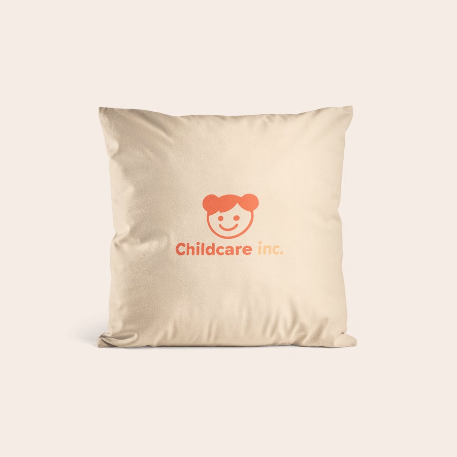 Personalised cushions & cushion cases Beige personalised cushion cover printed with a cartoon childs face and "Childcare inc." text.
