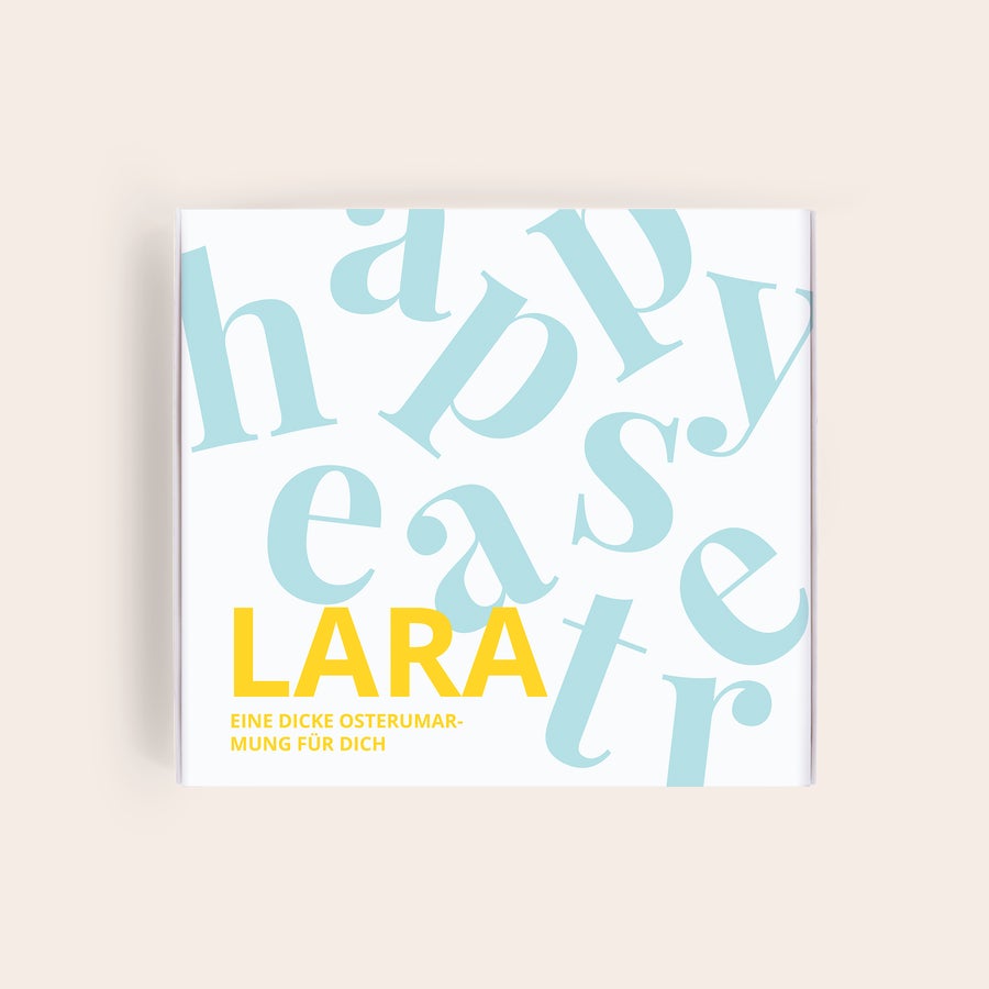 Milka Pralinen Ostern Personalisierte Milka-Geschenkbox mit Happy Easter Muster, dem Namen LARA und der Botschaft "EINE DICKE OSTERUMARMUNG FÜR DICH" bedruckt