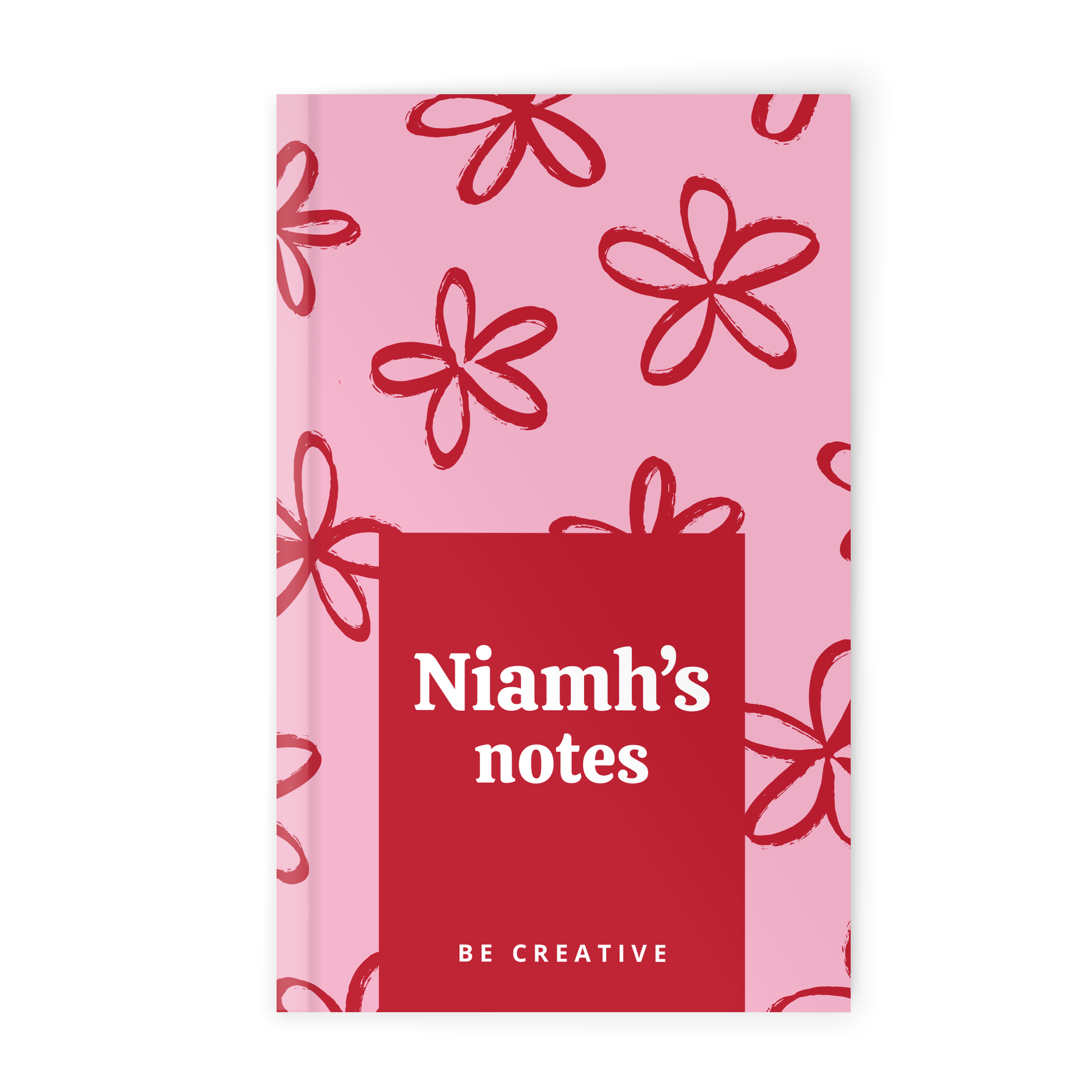 Cuaderno personalizado con estampado de flores rojas sobre fondo rosa y texto "Niamh's notes Be creative".