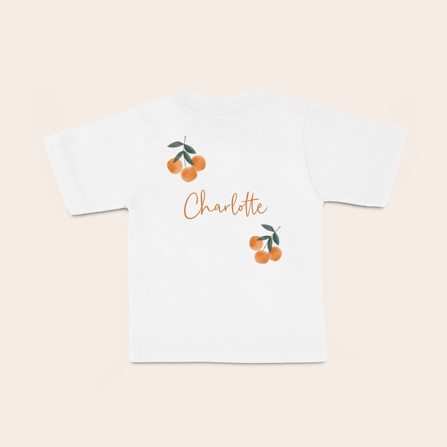 Personalised baby t shirt White baby shirt with oranges printed with the personalized name Charlotte