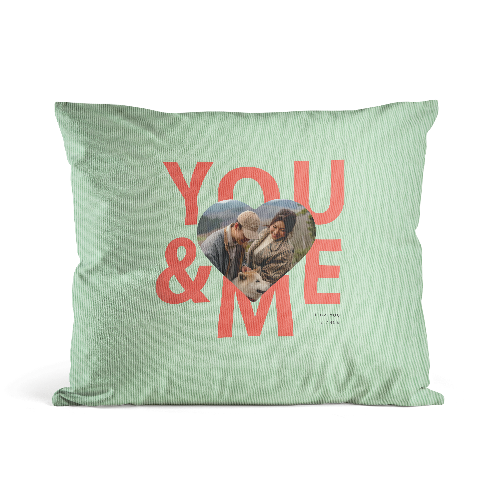 Personalised mint green cushion cover printed with "YOU & ME" and a heart-shaped photo of a couple with a dog.