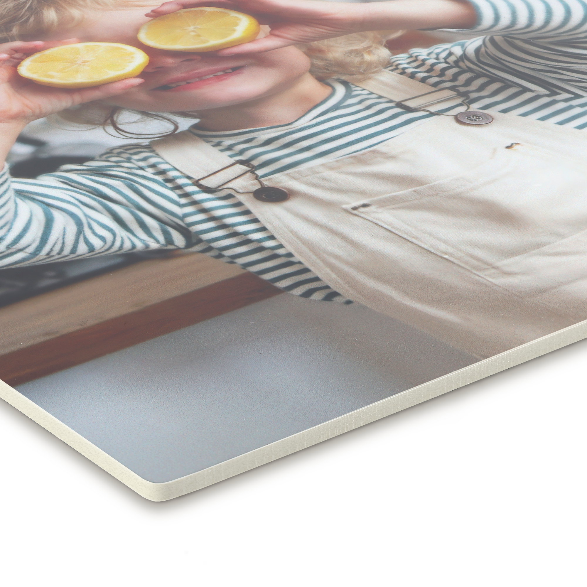 Forex wall art panel featuring a child with lemons over their eyes, ready to decorate your wall with a custom photo