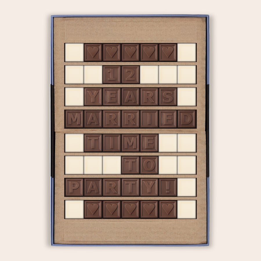 Personalised Chocolate Telegram Personal chocolate telegram with "12 YEARS MARRIED TIME TO PARTY!" and hearts, customized in a gift box.