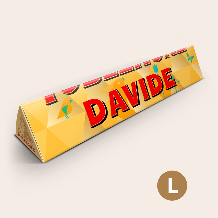 Toblerone Personalizzato - Pasqua Un delizioso Toblerone personalizzato con design pasquale, stampato con il nome Davide