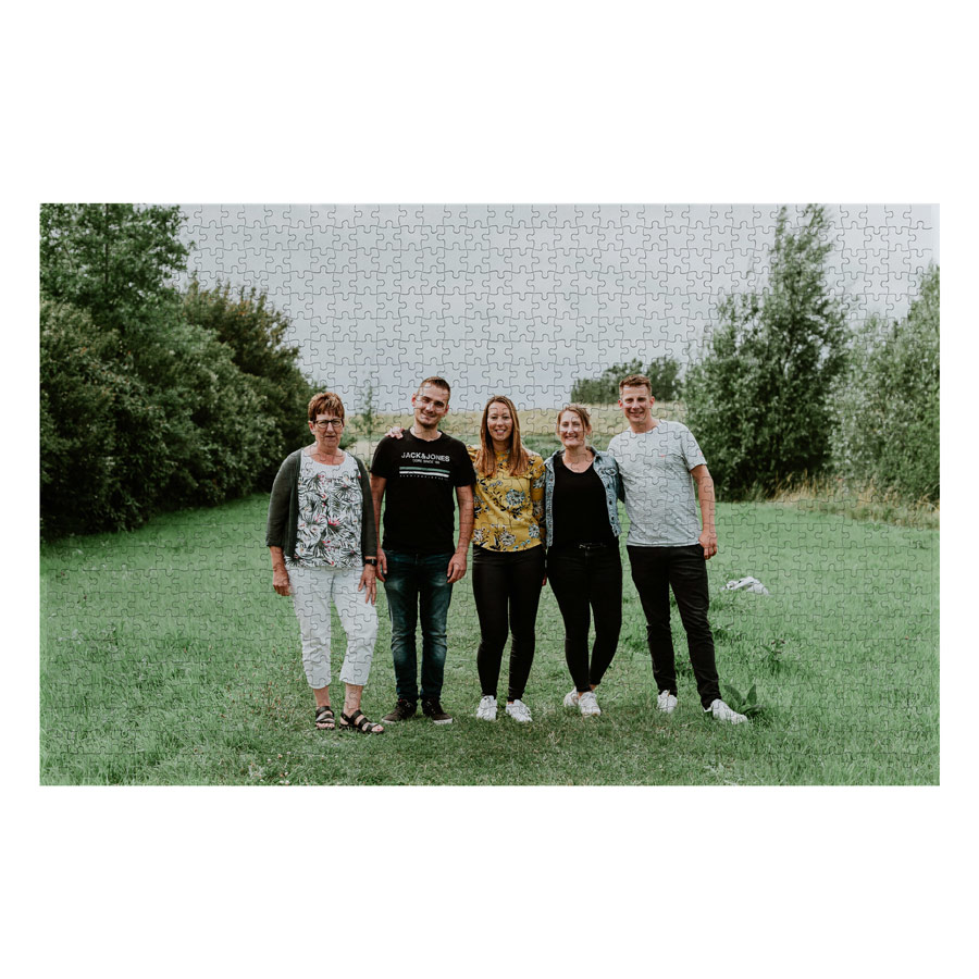 A personalized puzzle printed with a family photo in a grassy field