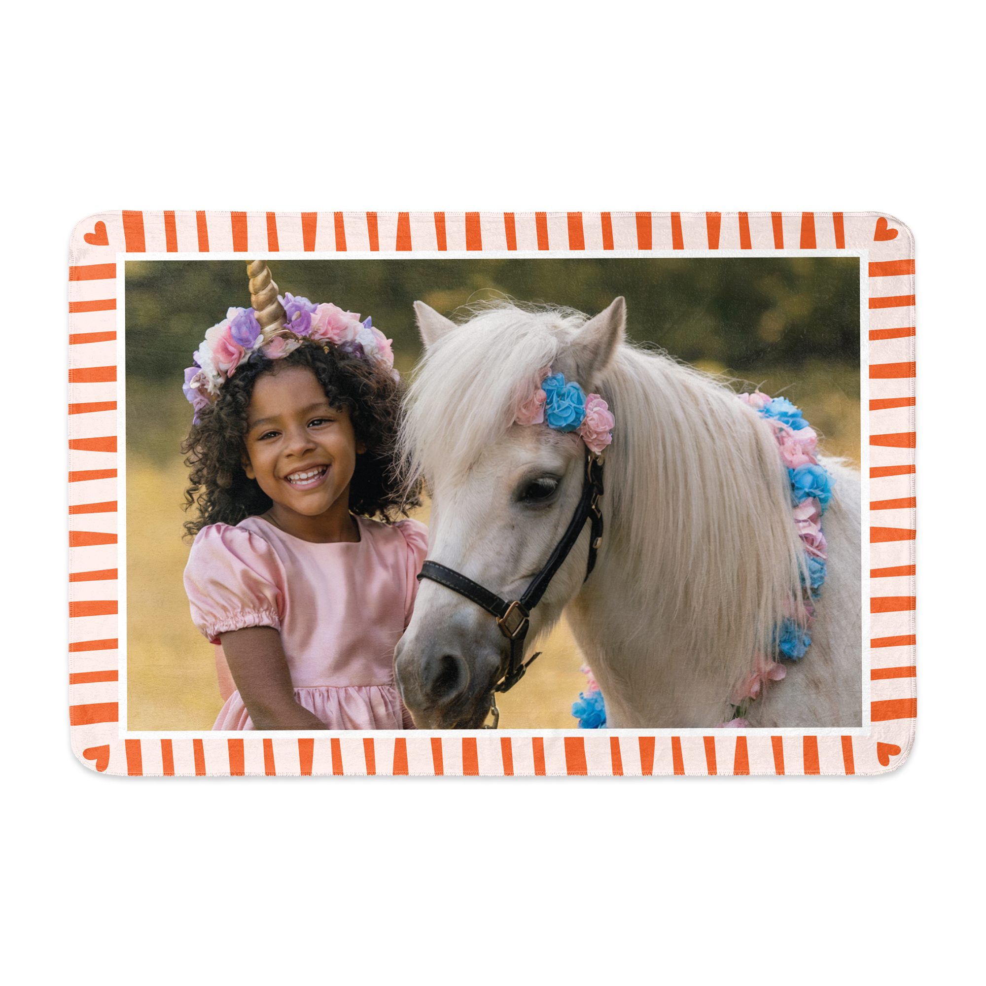 Personalised fleece blanket printed with a photo of a girl in a unicorn headband next to a white pony