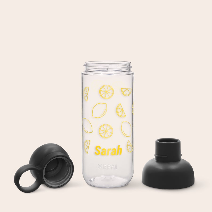 Mepal Vita Bottles Clear Mepal water bottle with lemon design and the name Sarah printed in yellow, with black caps removed.