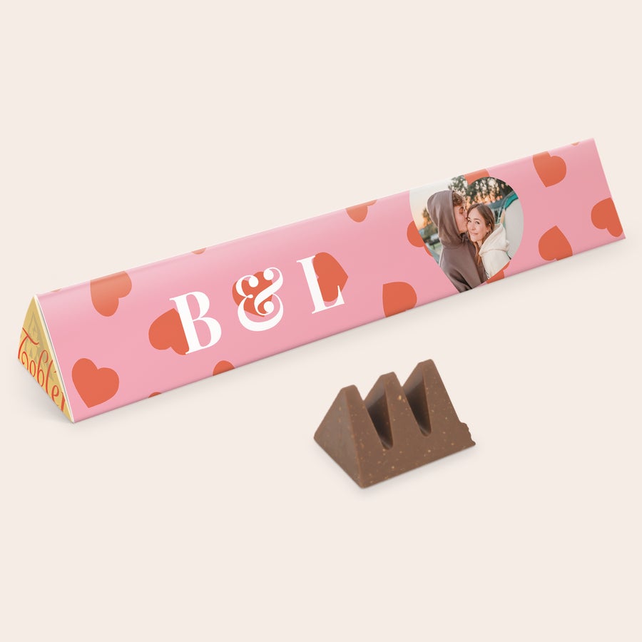 Toblerone XXL mit Namen Personalisierte Toblerone XXL mit Foto und "B & L" Namen auf rosaroter Verpackung mit Herzen, gedruckt.
