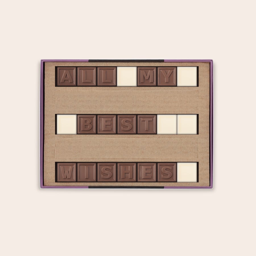 Chocotelegrama personalizado Telegrama de chocolate personalizado que dice "ALL MY BEST WISHES" en una caja, con letras de chocolate con leche y espacios de chocolate blanco.