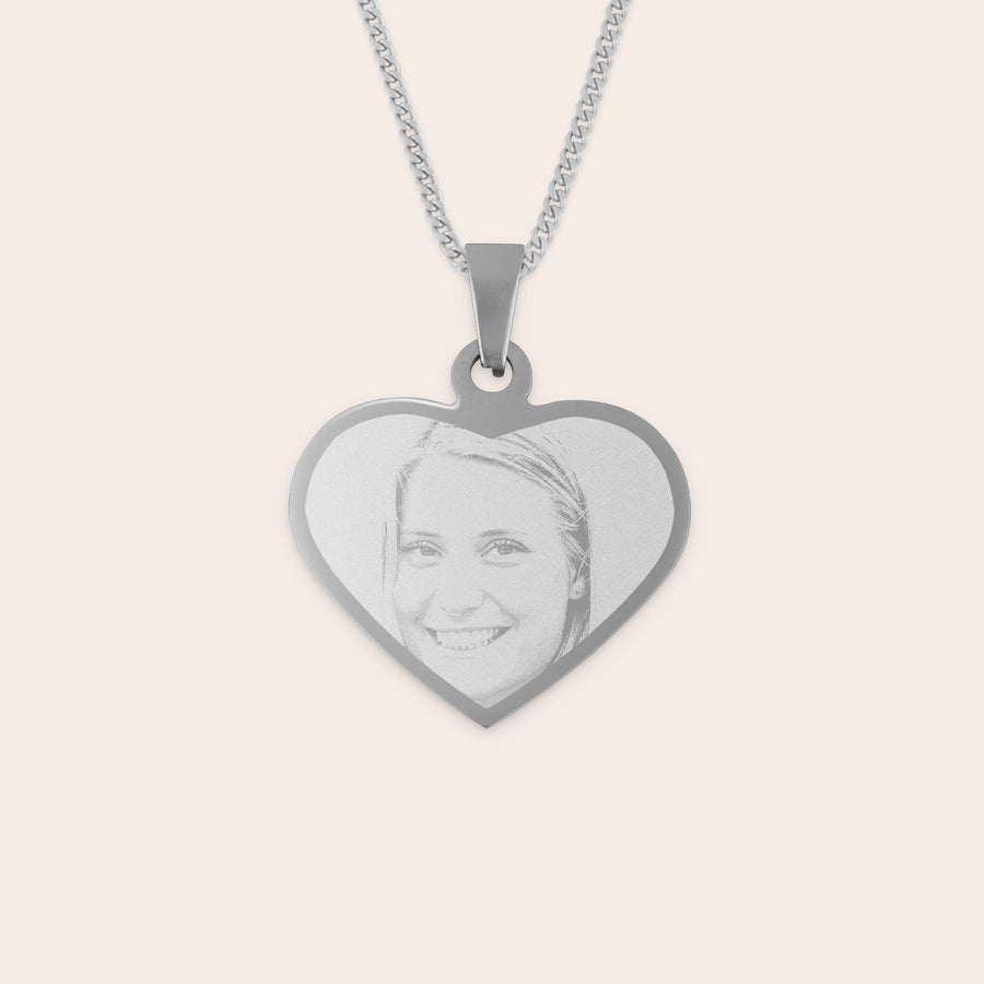 Engraved heart necklace Heart-shaped rhodium pendant engraved with a photo of a smiling woman.
